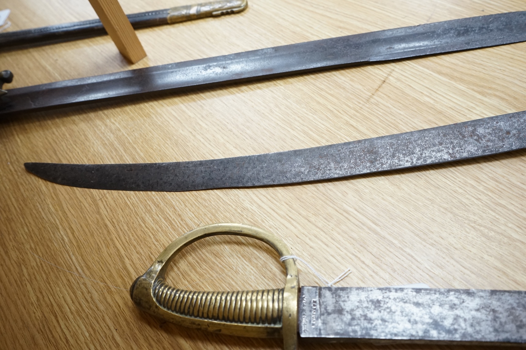 A mid 19th century infantryman’s short sword Gladius with cast brass hilt of universal pattern, stamped 306, together with two Continental infantyman’s side arm briquet, one stamped; M. and R. Boker Remscheid (3)